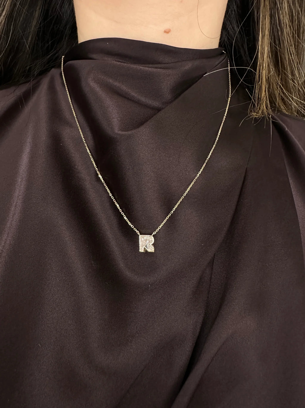 Necklace with a pendant on a dark fabric background