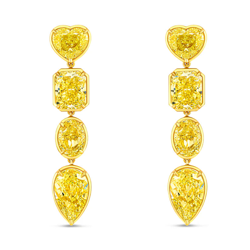 Pair of yellow diamond earrings on a white background