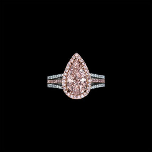 Rose gold ring with a pear-shaped pink diamond on a black background