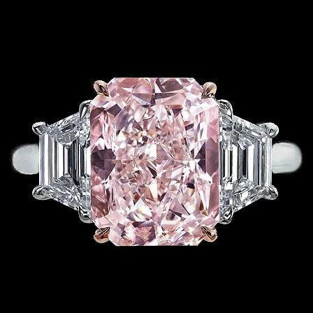 Pink diamond ring with emerald-cut and baguette-cut diamonds on a black background