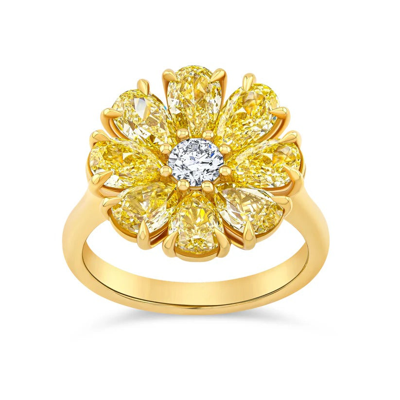 Gold ring with yellow and white gemstones on a white background