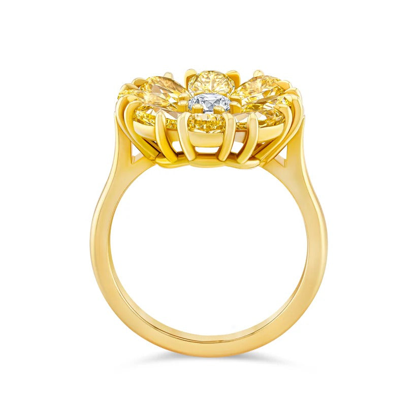 Gold ring with yellow gemstones on a white background