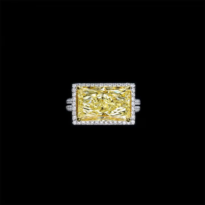 RADIANT FANCY YELLOW DIAMOND RING THE RING TOTALLING 8.13 CARATS HALO OF DIAMONDS